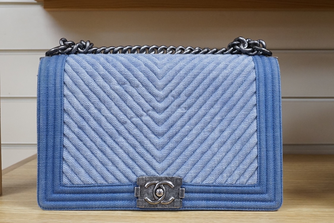 A Chanel denim cheveron flap shoulder bag with silver hardware, date code 20845697, 28cm wide